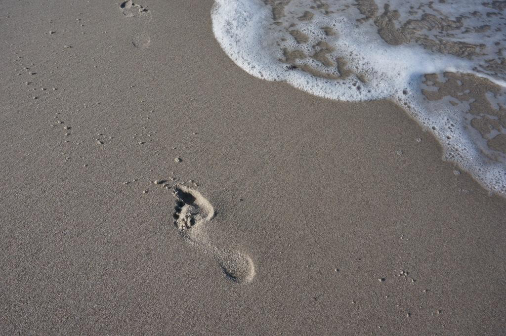 Mama-Fußabdruck am Strand